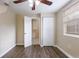 Bedroom with ceiling fan, wood-look floors and access to bathroom at 3723 N Garrison St, Tampa, FL 33619