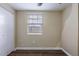 Simple bedroom with wood-look floors and window blinds at 3723 N Garrison St, Tampa, FL 33619