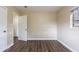 Bedroom with wood-look floors, and access to another room at 3723 N Garrison St, Tampa, FL 33619