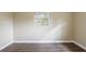 Simple bedroom with wood-look floors and a window at 3723 N Garrison St, Tampa, FL 33619