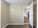 Bright bedroom with wood-look floors and a view of the kitchen at 3723 N Garrison St, Tampa, FL 33619