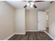 Bedroom with ceiling fan, wood-look floors, and access to bathroom at 3723 N Garrison St, Tampa, FL 33619