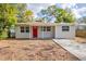 Charming house with a red front door, freshly painted exterior and a small front yard at 3723 N Garrison St, Tampa, FL 33619