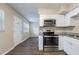 Eat-in kitchen with stainless steel appliances and white cabinets at 3723 N Garrison St, Tampa, FL 33619