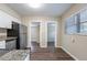 Modern kitchen with white cabinets, stainless steel appliances, and granite countertops at 3723 N Garrison St, Tampa, FL 33619