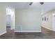 Living area with hardwood floors, neutral walls and doors to other rooms at 3723 N Garrison St, Tampa, FL 33619