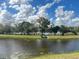 Tranquil lake view surrounded by trees and lush greenery at 4280 Banjo Lake Rd, Land O Lakes, FL 34639