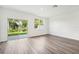 Bright living room with wood-look flooring and sliding glass doors to the backyard at 4280 Banjo Lake Rd, Land O Lakes, FL 34639