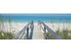 Scenic beach access via a boardwalk leading to pristine white sand and turquoise waters at 5855 Midnight Pass Rd # 108, Sarasota, FL 34242