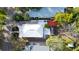 Aerial view of a home with white roof, detached garage, and backyard at 603 W Emma St, Tampa, FL 33603