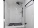 Modern shower with marble tile, black accents, and rainfall showerhead at 603 W Emma St, Tampa, FL 33603