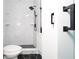 Modern bathroom with marble tile, black accents, and a walk-in shower at 603 W Emma St, Tampa, FL 33603