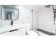 Bathroom with marble shower, black fixtures, and a floating vanity at 603 W Emma St, Tampa, FL 33603