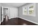 Bedroom with dark wood floors, white closet doors, and large windows with shutters at 603 W Emma St, Tampa, FL 33603