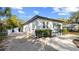Charming white brick home with landscaped front yard and paved driveway at 603 W Emma St, Tampa, FL 33603