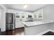 Updated kitchen featuring white cabinets, stainless steel appliances, and a white countertop at 603 W Emma St, Tampa, FL 33603