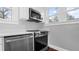 Kitchen detail showcasing stainless steel appliances and white countertops at 603 W Emma St, Tampa, FL 33603