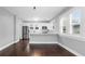 Modern kitchen with white cabinets, stainless steel appliances, and dark wood floors at 603 W Emma St, Tampa, FL 33603