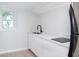 Kitchenette with white cabinets, black sink and stove top at 603 W Emma St, Tampa, FL 33603