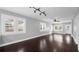 Spacious living room with dark wood floors, large windows, and a ceiling fan at 603 W Emma St, Tampa, FL 33603