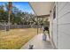 Covered back patio with grill, clothesline, fenced backyard at 4920 Sedeno Dr, Zephyrhills, FL 33541