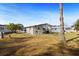 Expansive backyard with a tree, clothesline, and a storage shed at 4920 Sedeno Dr, Zephyrhills, FL 33541