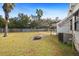 Spacious backyard with fire pit and clothesline at 4920 Sedeno Dr, Zephyrhills, FL 33541
