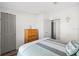 Another view of the guest bedroom with a bed, dresser, and closet at 4920 Sedeno Dr, Zephyrhills, FL 33541