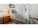 Bright guest bedroom with comfortable bedding and ample natural light at 4920 Sedeno Dr, Zephyrhills, FL 33541