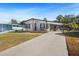 Front exterior of a single-story home with a covered carport and driveway at 4920 Sedeno Dr, Zephyrhills, FL 33541