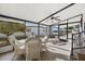 Screened porch with wicker furniture, ceiling fan, and views of the community at 4920 Sedeno Dr, Zephyrhills, FL 33541