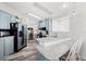 Well-lit kitchen featuring blue cabinets, stainless steel appliances, and a breakfast bar area at 4920 Sedeno Dr, Zephyrhills, FL 33541