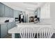 Modern kitchen with gray cabinets, stainless steel appliances, and a breakfast bar at 4920 Sedeno Dr, Zephyrhills, FL 33541