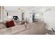 Living room featuring a sectional sofa, and a partial view of the kitchen at 4920 Sedeno Dr, Zephyrhills, FL 33541