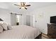 Spacious main bedroom with a king-size bed, ensuite bathroom, and sliding barn door at 4920 Sedeno Dr, Zephyrhills, FL 33541