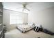 Simple bedroom with ceiling fan, window, and carpeted floors at 11807 Holly Creek Dr, Riverview, FL 33569