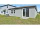 Home backyard featuring a sliding glass door leading onto the freshly cut green grass at 14061 Crutchfield Ct, Parrish, FL 34219