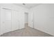 Bedroom features a carpeted floor, closet, and a doorway to the adjacent room at 14061 Crutchfield Ct, Parrish, FL 34219