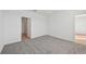 Carpeted bedroom with open doorway to another room at 14061 Crutchfield Ct, Parrish, FL 34219