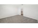 Carpeted bedroom with open door to ensuite bathroom at 14061 Crutchfield Ct, Parrish, FL 34219