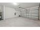 Spacious garage with plenty of room for storage and parking, featuring a metal garage door at 14061 Crutchfield Ct, Parrish, FL 34219