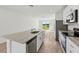 Kitchen featuring a granite countertop island with a stainless steel sink and appliances at 14061 Crutchfield Ct, Parrish, FL 34219