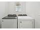 Laundry room features a brand new washer and dryer with bright light entering from a window at 14061 Crutchfield Ct, Parrish, FL 34219