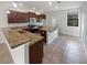 Kitchen with island, granite counters, stainless appliances, and tiled floor at 17652 Terrazzo Way, Land O Lakes, FL 34638