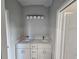 Double vanity bathroom with modern light fixture at 2840 S Biscayne Dr, North Port, FL 34287