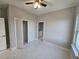 Well-lit bedroom with ceiling fan and built-in closet at 2840 S Biscayne Dr, North Port, FL 34287