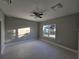 Spacious bedroom with ceiling fan and large window at 2840 S Biscayne Dr, North Port, FL 34287