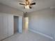 Bright bedroom with ceiling fan and double-door closet at 2840 S Biscayne Dr, North Port, FL 34287