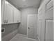 Bright laundry room with white cabinets and quartz countertop at 2840 S Biscayne Dr, North Port, FL 34287