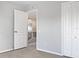 Bedroom with an open door leading to a hallway with a staircase at 12415 Cedarfield Dr, Riverview, FL 33579